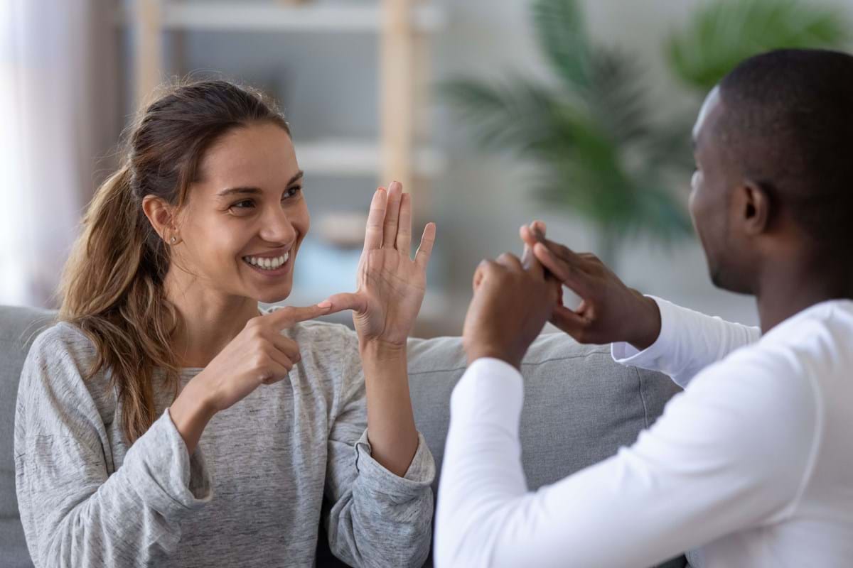 a man and a woman communicating through ASL